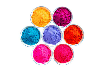 Top-down view of multiple round plates filled with vibrant Gulal powders, neatly arranged in a circular pattern on a white background.
