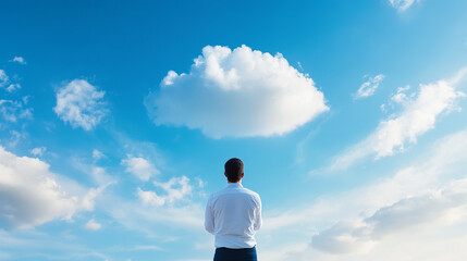 man in white shirt gazes at cloud filled sky, reflecting on possibilities