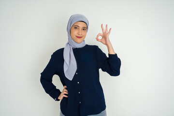 Confident Woman in Hijab Making OK Gesture and Smiling on White Background