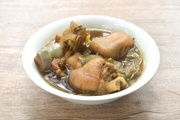 boiled braised salty pork leg and chop cabbage in Chinese herb soup in bowl 