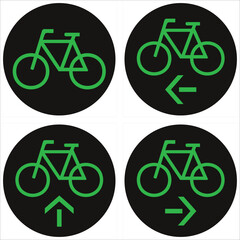 Fototapeta premium Four round black signs showing green bicycle symbol for different allowed directions