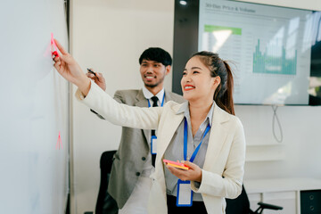 Fototapeta premium Woman and a man are drawing on a whiteboard