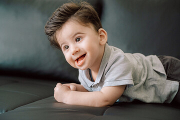 Smiling Child Relaxing on a Couch in a Comfortable Indoor Environment