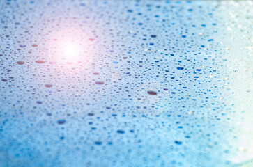 Water droplets on an ocean blue color background with customizable space for text or ideas