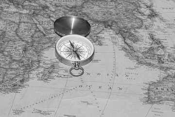 Classic round compass on background of old vintage map