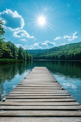 Wooden pier extending into calm lake surrounded by green hills under bright sun and blue sky