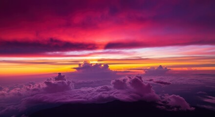 Fototapeta premium Vibrant sunset over clouds, showcasing a stunning array of colors
