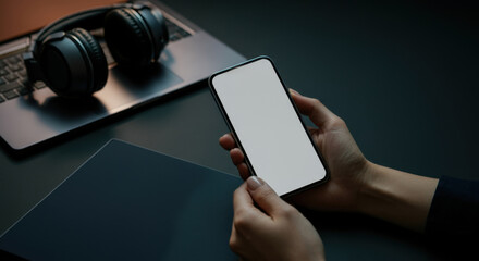 Mockup of a smartphone held in hands with a blank screen for design