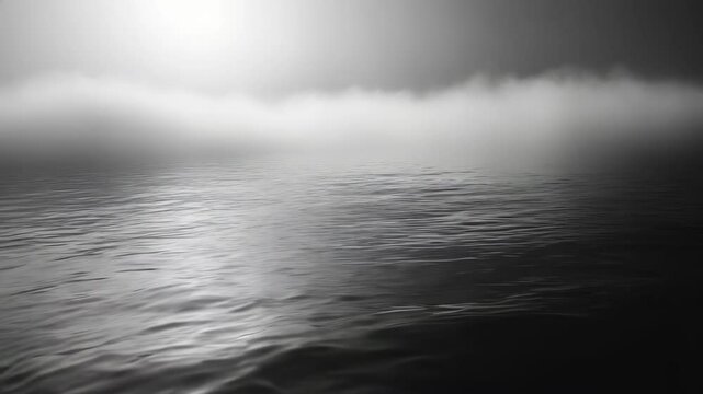 thick gray fog softly swirling against a backdrop of darkness. This atmospheric image of mist captures the ethereal beauty of nature's veiled mystery