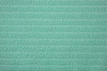 Textile close up of a green  fabric, fabric texture as a background.