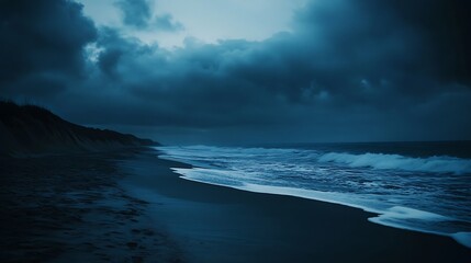 Dark clouds hover over the sandy beach and its ocean waves