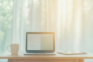 Fototapeta premium Bright workspace featuring laptop and coffee cup, bathed in soft