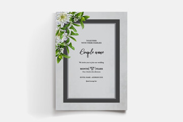 WEDDING INVITATION FRAME WITH FLOWER DECORATIONS AND FRESH LEAVES