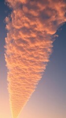 Fototapeta premium A majestic stratocumulus cloud stretches across the sky at dusk, atmospheric, golden hour
