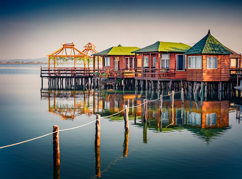 Superb morning view of fishing dock on popular tourist attraction Patocut Laguna. Cakm morning seascape of Adriatic sea, Albania, Europe. Traveling concept background.