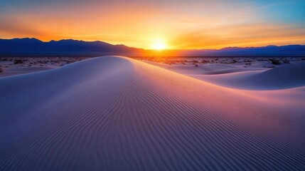 Fototapeta premium Sunset colors illuminate a desert landscape with vast sand dunes