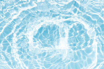 Blue water with ripples on the surface. Defocus blurred transparent blue colored clear calm water surface texture with splashes and bubbles. Water waves with shining pattern texture background.