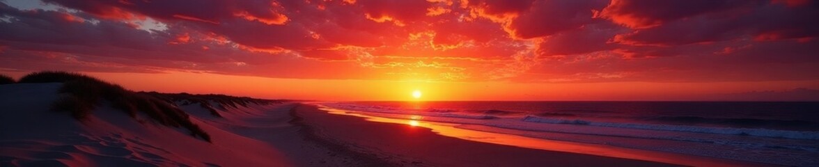 Fototapeta premium Dramatic sunset over Glenelg Beach; silhouetted dunes against fiery sky , twilight, evening, vibrant