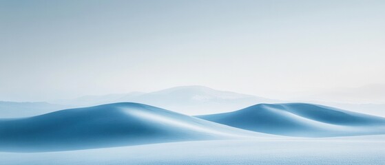 Snow-covered mountains bathed in soft morning light creating a serene winter landscape