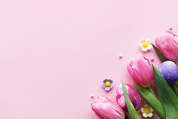 Easter flat lay. Stylish marble easter eggs and pink tulips on pink background with space for text....