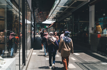 Unrecognizable people walking on street in city