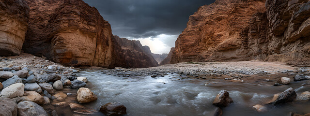 A stunning photograph of the narrow river flowing through a desert canyon, with rocky walls towering on both sides
