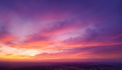 Obraz premium A breathtaking sunset sky transitioning through soft gradient hues of pink, orange, and purple, creating a dreamy and atmospheric scene.