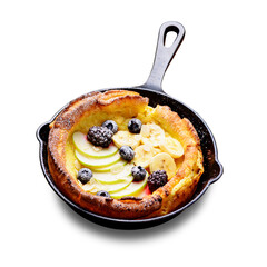 Dutch baby pancake with apples, banana, fresh berries powdered sugar and almonds. isolated on white background	
