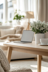 A bright workspace featuring a modern desk, a laptop, and a small potted plant placed neatly on the desk for a touch of greenery