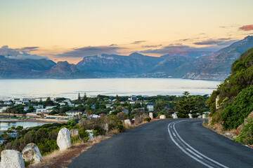 The view from above Kommetjie, Cape Town, South Africa. A road leads down the mountain and looks out over Chapmans peak. Photo taken at sunset