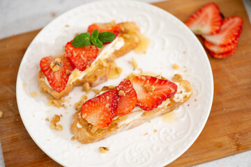 Bruschetta with strawberries. fried in batter toast with cream cheese