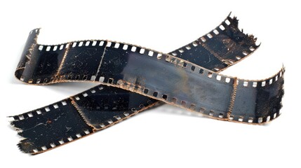 Fototapeta premium Vintage damaged film strip with scratches and tears on white background for nostalgia and retro design