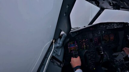 Pilot navigates through cloudy skies with precise controls and instruments during a flight