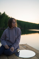 Fototapeta premium Woman on the pier at lake