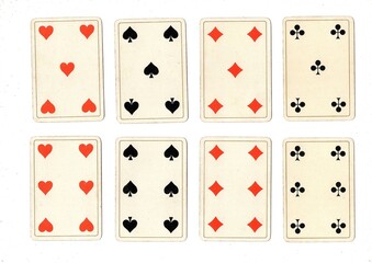 Antique playing cards showing four of the same value.