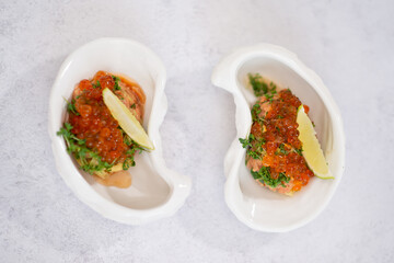 Salmon tartare appetizer with caviar. Mini tartlets with red salmon caviar