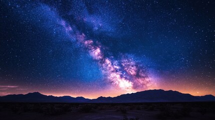 Fototapeta premium Starry night sky with visible milky way galaxy over mountain range landscape