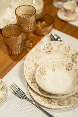 Close up on luxury italian tableware, dishes and glasses.