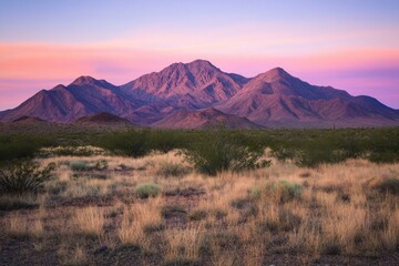 Obraz premium Desert sunset casting golden hues on mountain peaks near phoenix, arizona for avid nature photographers and adventure seekers capturing stunning landscapes