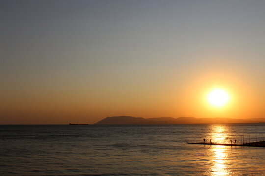 Sunset at the sea. Beautiful landscape with sun reflection on the water. - Powered by Adobe