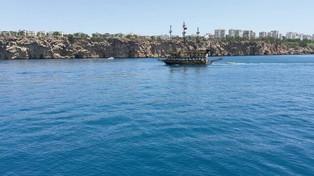 Tourist pirate ship on horizon of Mediterranean Sea, Turkey coast.