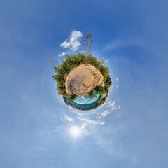 simple little tiny planet without buildings in blue sky with sun and beautiful clouds....