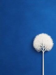 Fototapeta premium A minimalist white tree on a vibrant blue background, symbolizing simplicity and elegance.