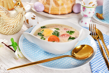 Easter table with traditional white borscht with egg and sausage