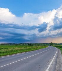 Road with a cloudy sky in the background