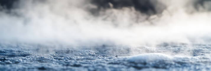 Fototapeta premium Close-up of steam rising from a heated water surface with bubbles