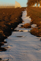 A snowy landscape with a mountain in the distance