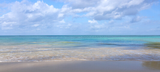 Tropical paradise beach with white sand and blue sky.