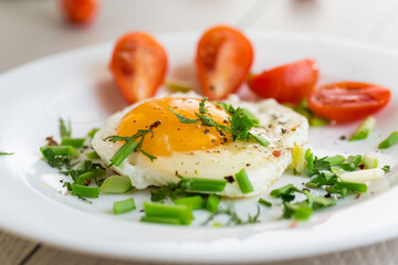 Fresh breakfast with egg, greens and spices