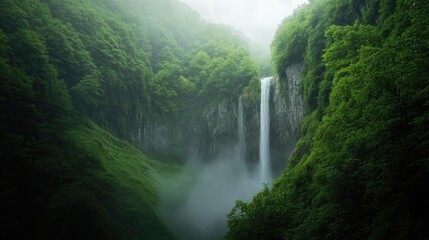 Fototapeta premium Serene Waterfall Surrounded by Lush Green Forest in Misty Landscape